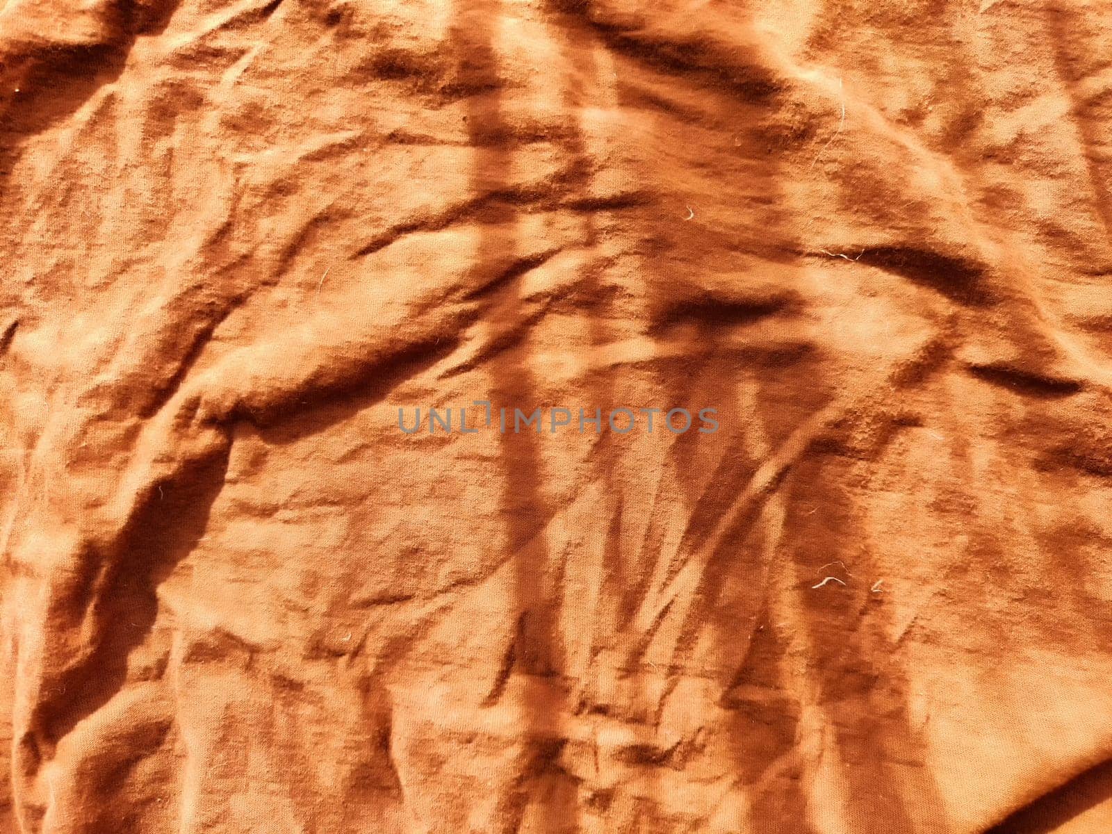 Abstract background and texture of crumpled brown fabric. Texture, pattern, frame and copy space