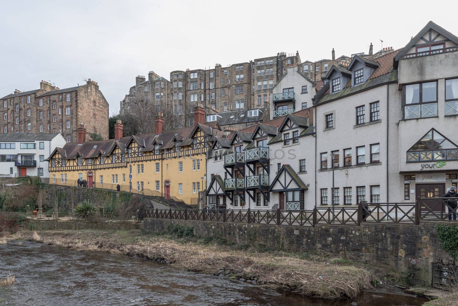 Edinburgh, Scotland - Jan 16, 2024 - Hawthorn Buildings is a traditional old Tenement building on Hawthornbank Lane in Dean Village with river and stream which sits along the banks of the Water of Leith. Space for text, Selective focus.