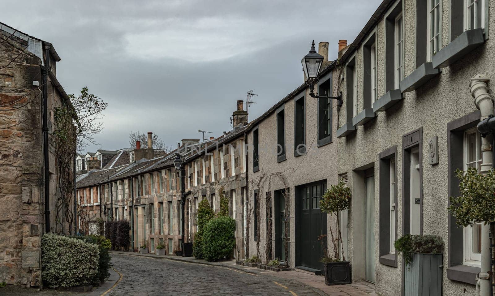 Edinburgh, Scotland - Jan 16, 2024 - Perspective view of Circus Lane is a picturesque cobbled street in Stockbridge of Edinburgh, This residential street with pretty flower-covered terraced mews houses. Copy space, Selective focus.