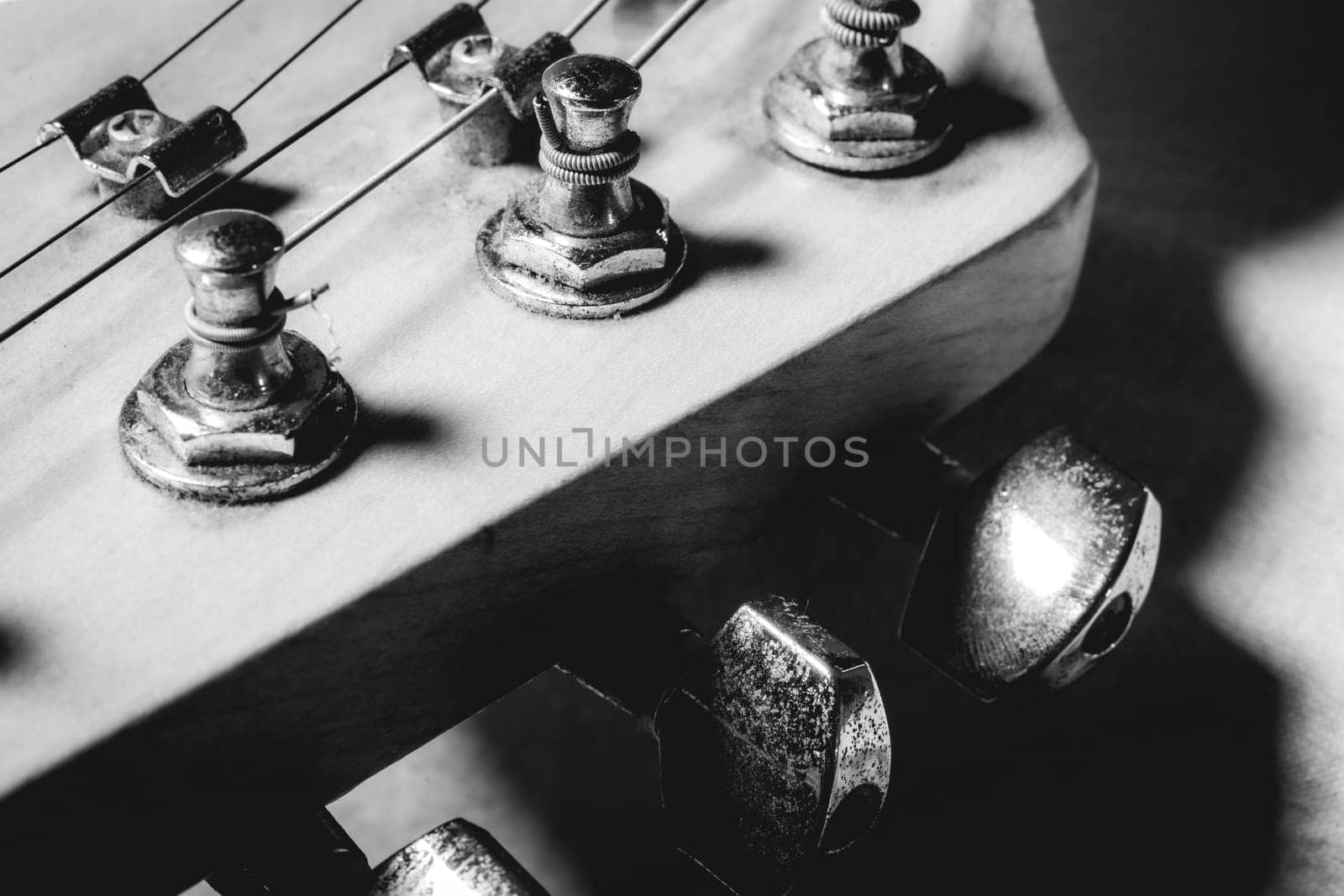 Close up from an old vintage guitar headstock , Full with dust. In black and white.