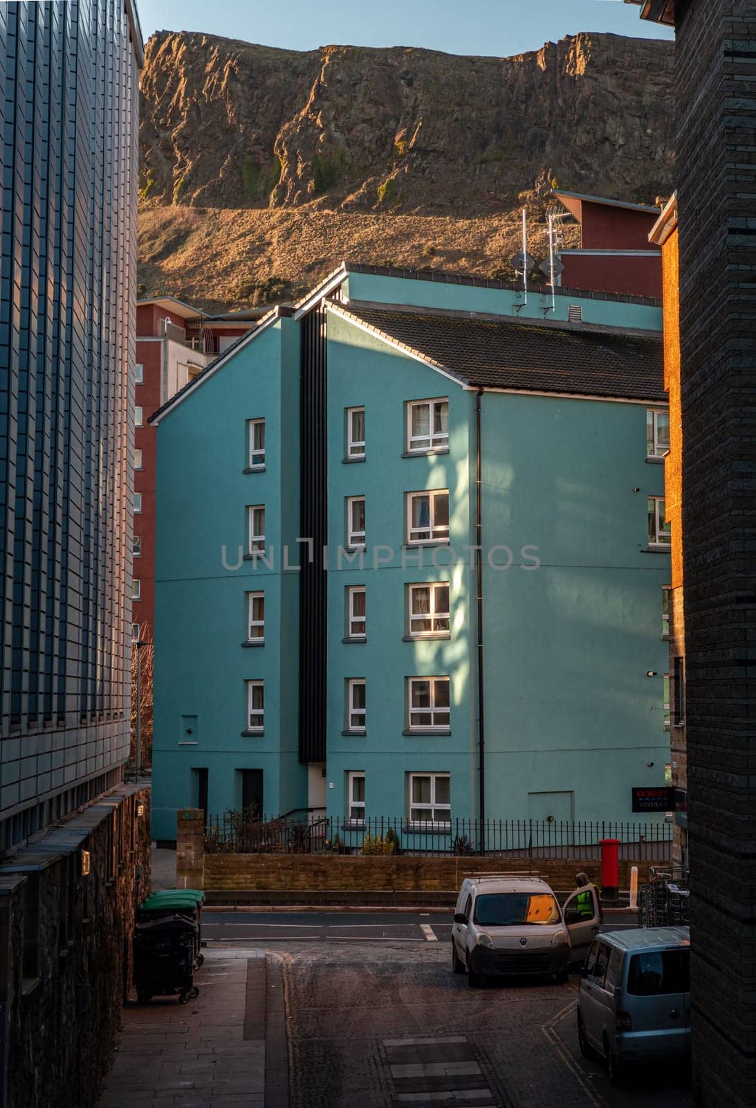Edinburgh, Scotland - Jan 18, 2024 - View of modern apartment building in Dumbiedykes housing estate area in Viewcraig Gardens with Arthur's Seat view in background. Residential modern architecture in Edinburgh city centre Scotland, Tenement houses, Blocks and flats, Space for text, Selective focus.