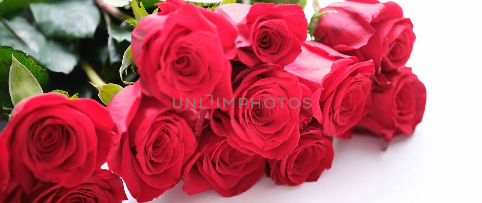 Close-up of luxury bouquet made of red roses, flower shop. Birthday, Valentines or mother's day celebration. Festive events concept