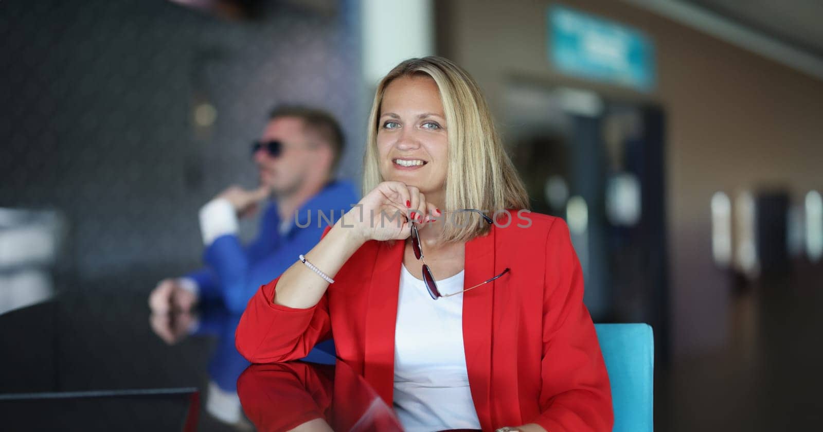 Portrait of happy smiling businesswoman posing in business clothes. Cheerful woman looking at camera with happiness. Business trip concept