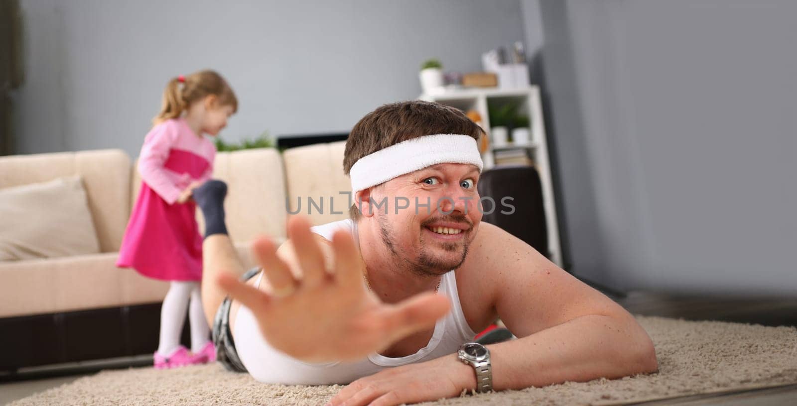 Portrait of middle-aged man doing sport exercises at home. Male in sports blindfold having home workout online. Sportlife and healthy lifestyle