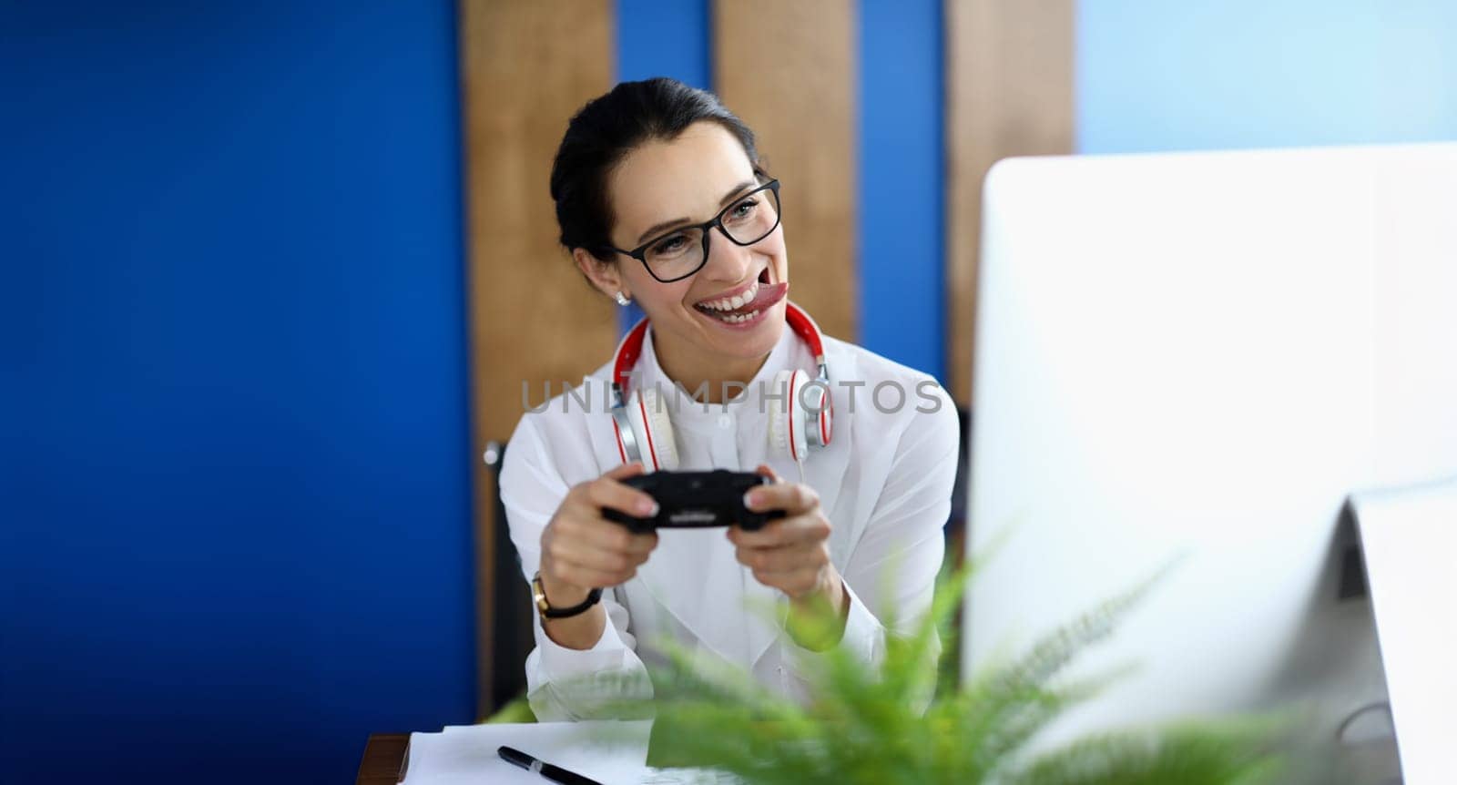Portrait of joyful woman having fun with game console. Funny female play pc game with joystick console. Crazy smiling woman playing videogames. Game tester