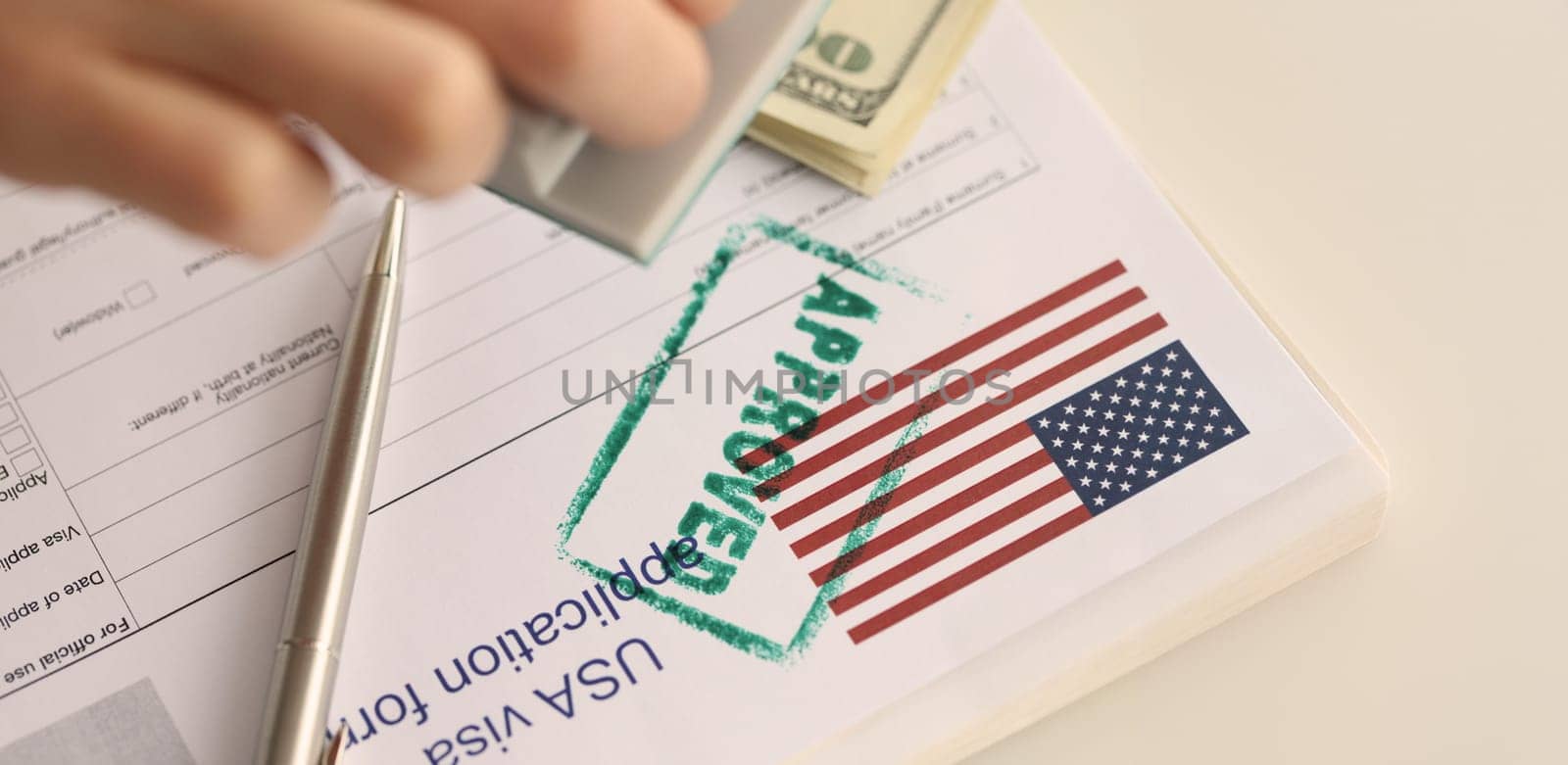 Close-up of USA visa approved, application form for emigration abroad. Visa approved with rubber stamp, american flag. Embassy and immigration services