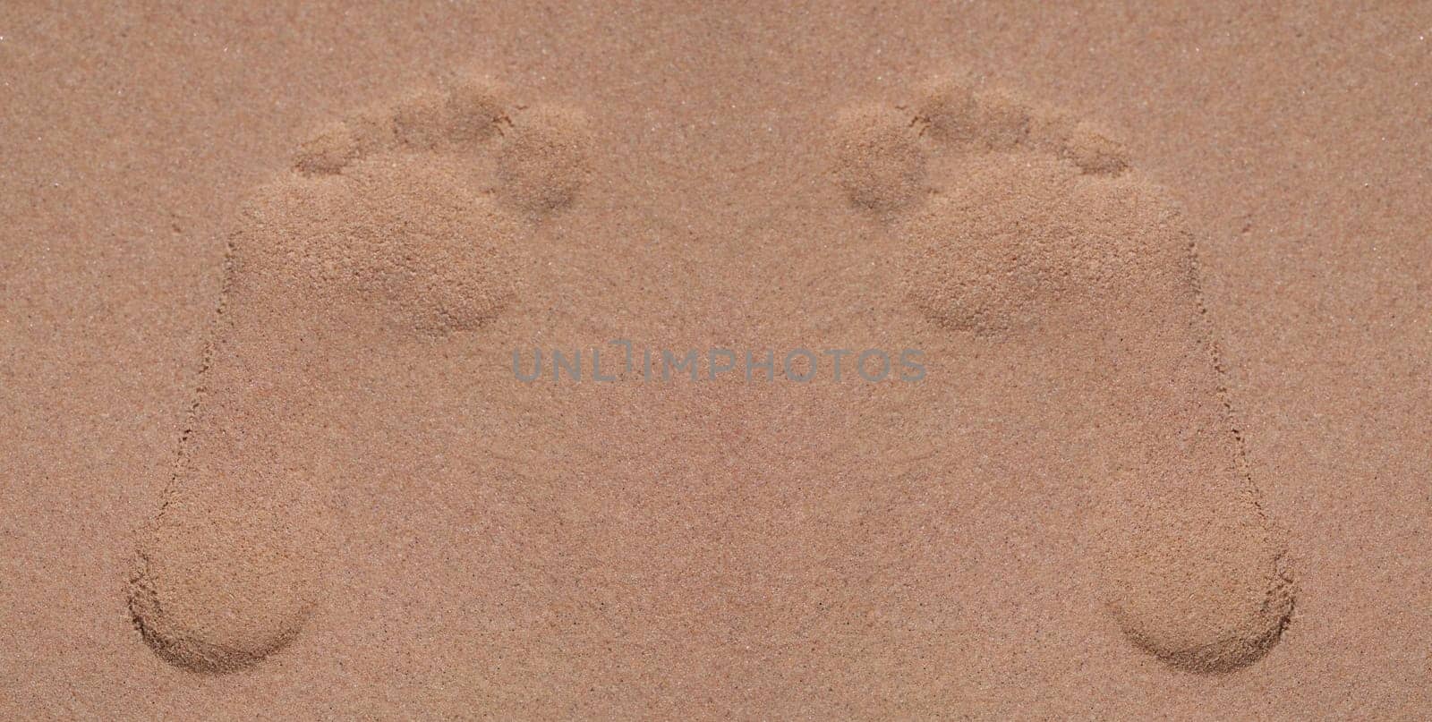 Top view of footprints in sand at beach, lonely trace on sandy surface on coast. Summer sea vacation and leisure at sea concept