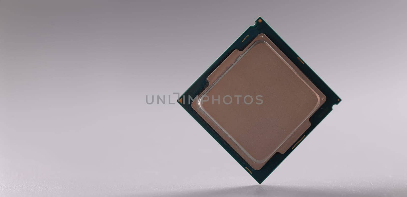 Close-up of central processing unit, processor chip on grey background. Chipping and microcircuits, modern technology and innovation concept