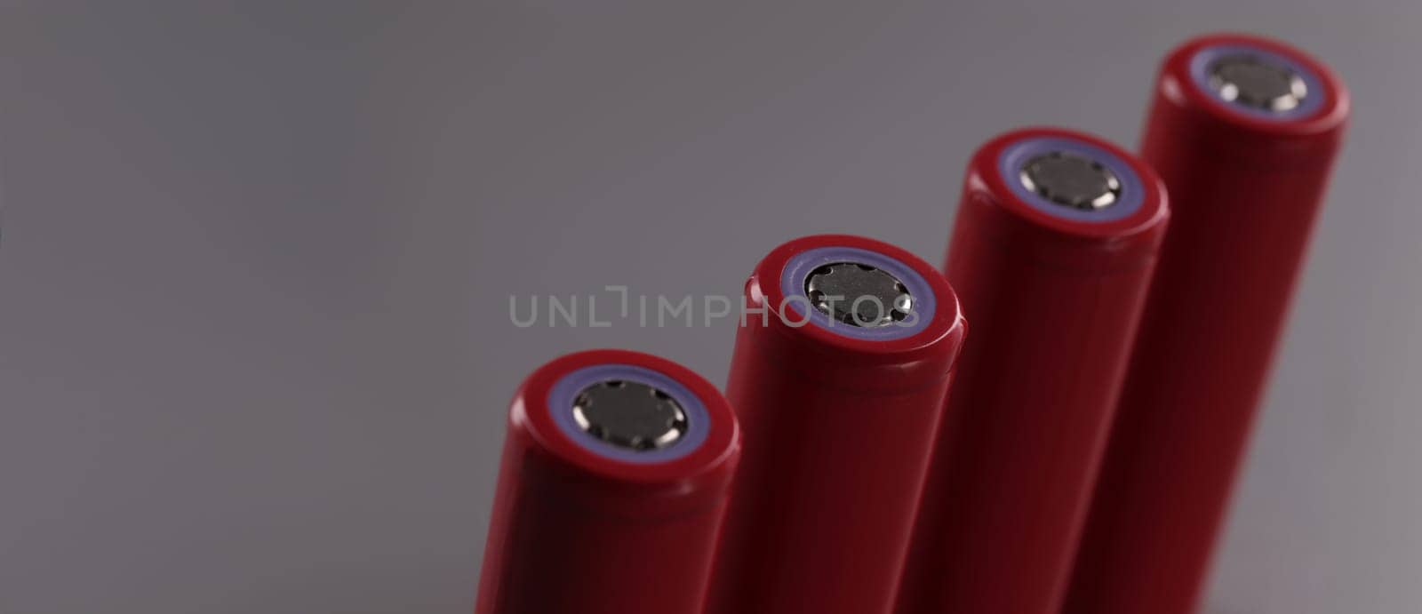 Close-up of four rechargeable batteries set, lithium battery and important power source. Battery mods with electrical energy. Power concept