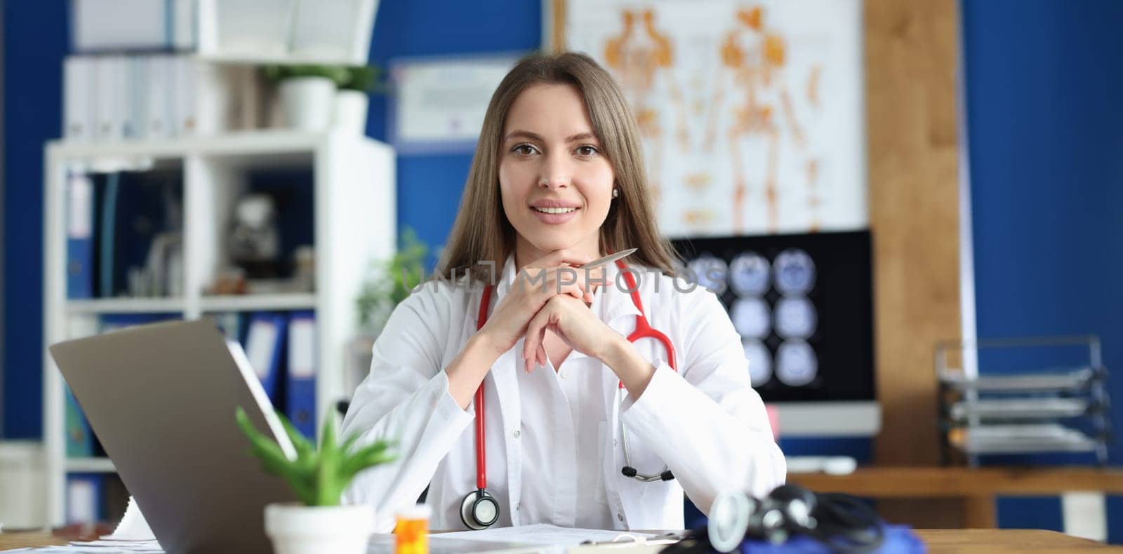 Portrait of smiling female doctor in gown, young medical specialist working in clinic. Healthcare, medicine, emergence and save life concept