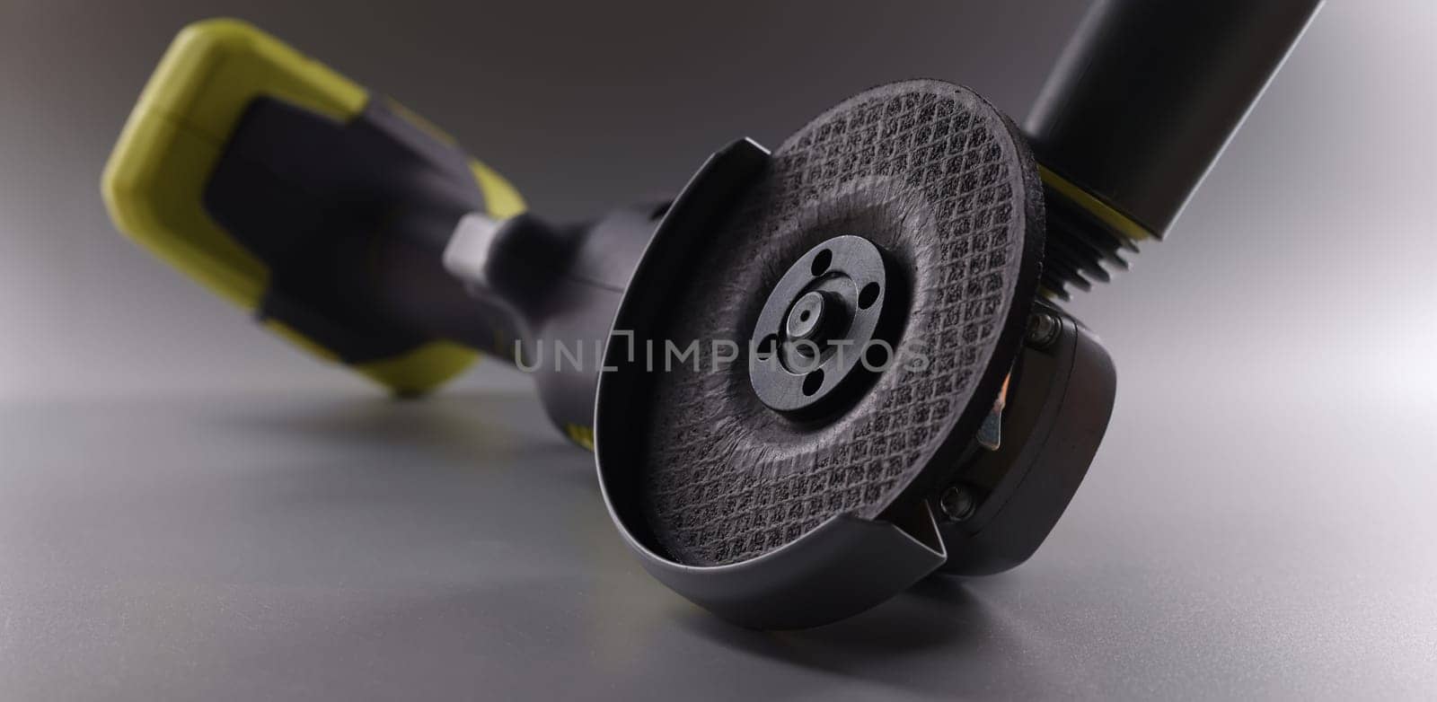 Close-up of powerful circular saw equipment for construction works. Electrical saw, grinder for metal works on grey background. Carpentry concept