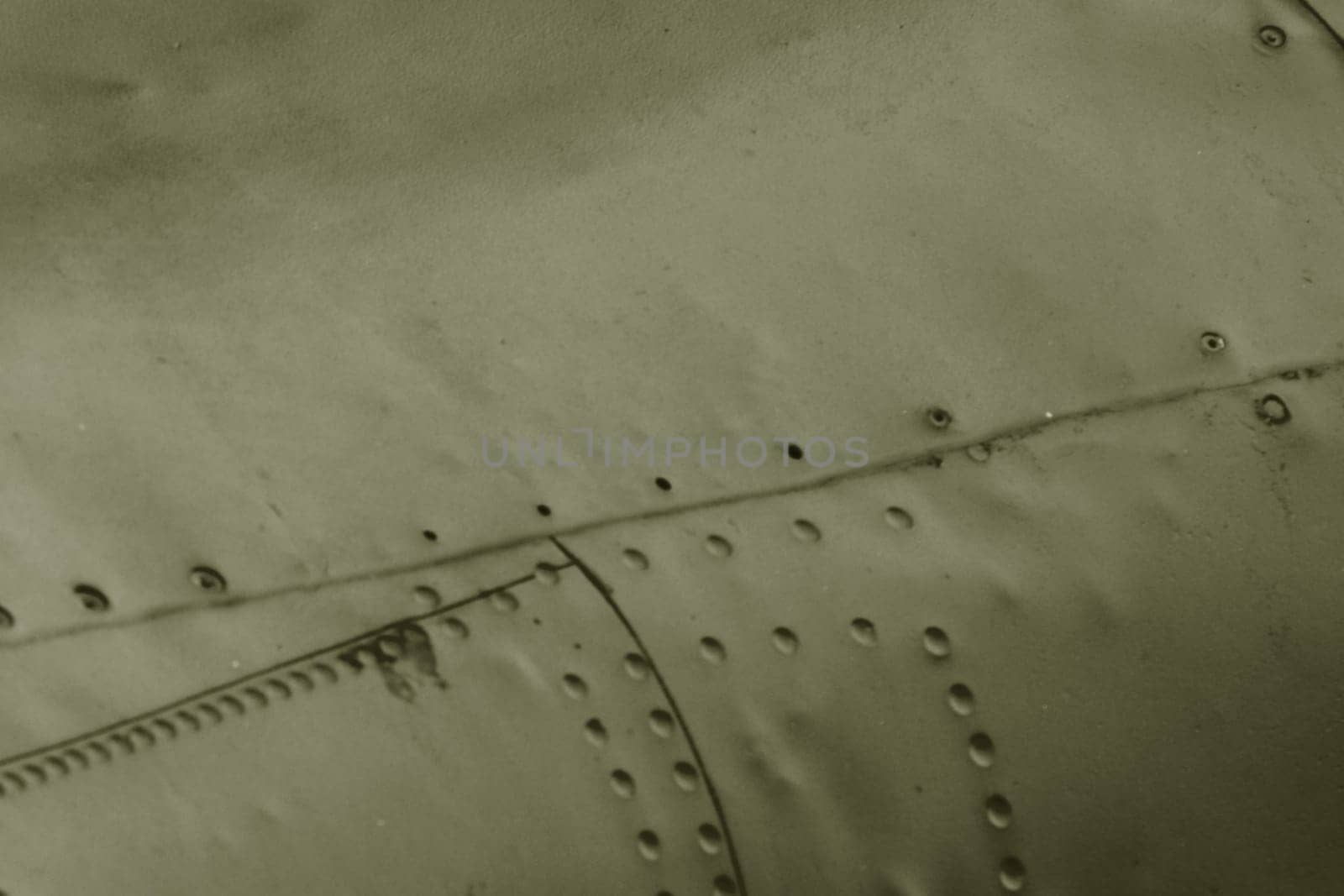 The side of the aircraft is painted green with rivets.