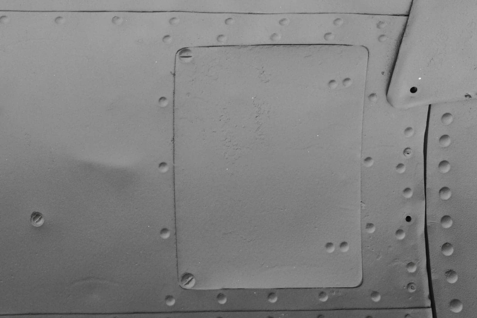 Abstract sheet iron background with rivets. Fragment of an airplane fuselage.