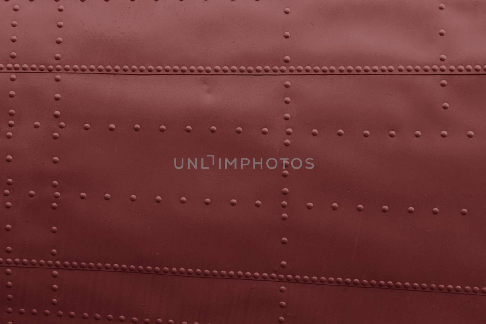 Protection of military equipment made of sheet metal with red rivets.