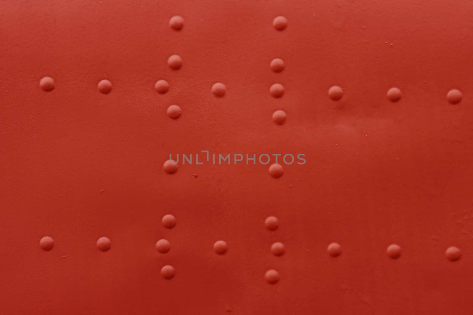 The surface of an old damaged aircraft skin with rivets.
