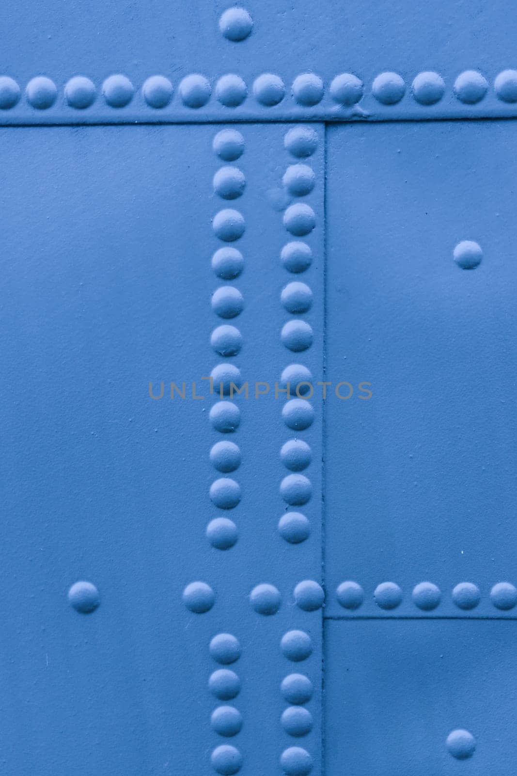 Protection of military equipment made of sheet metal with blue rivets.
