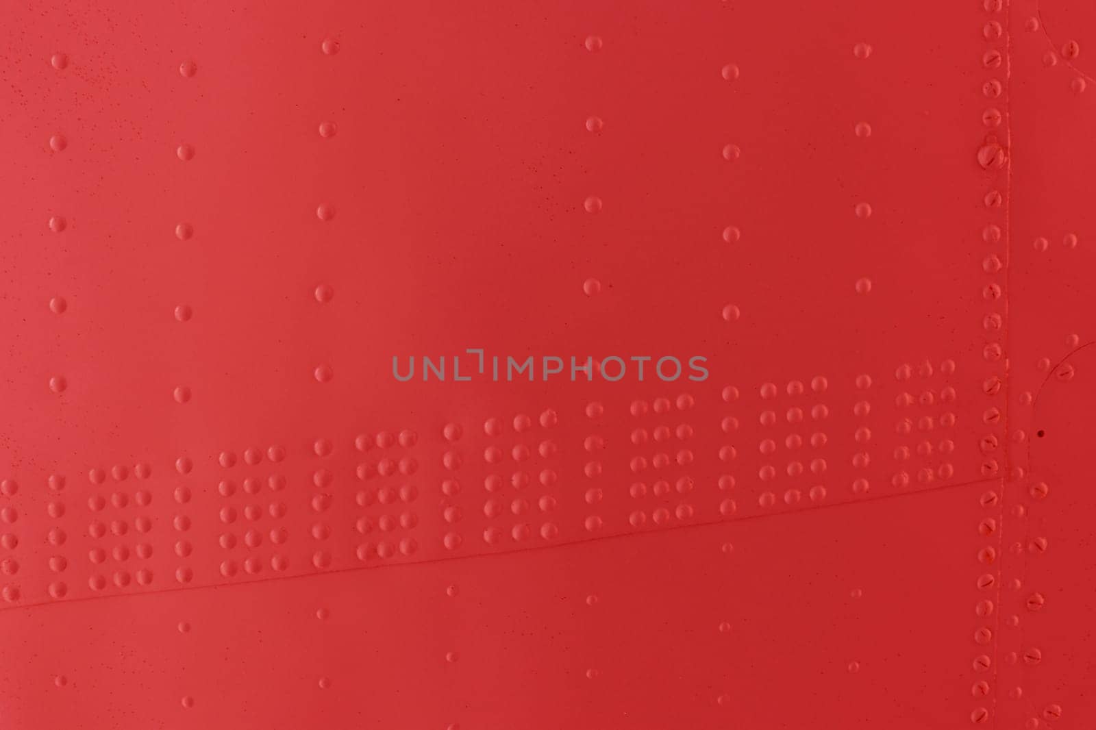 Protection of military equipment made of sheet metal with red rivets.