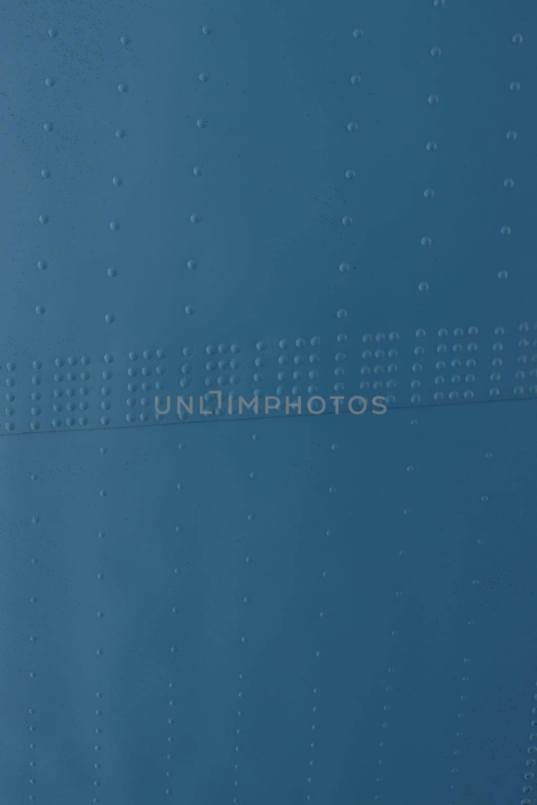 Protection of military equipment made of sheet metal with blue rivets.