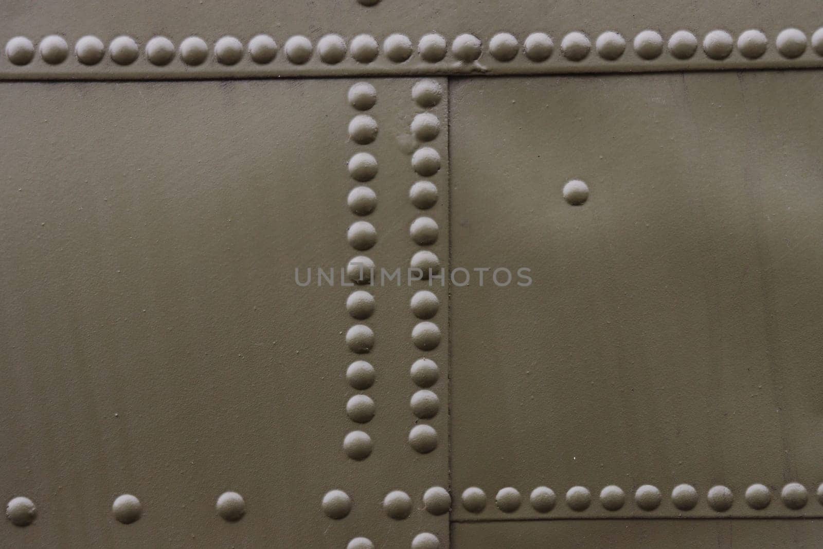 Riveted painted metal background texture.