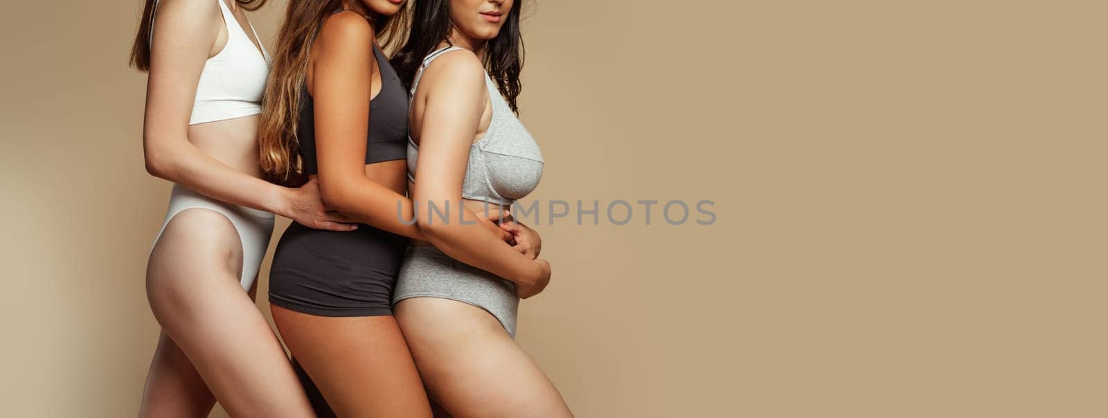 Millennial international women in underwear enjoy natural beauty, different body types, isolated on beige background, studio, cropped. Motivation for self love, wellness or health care, copy space