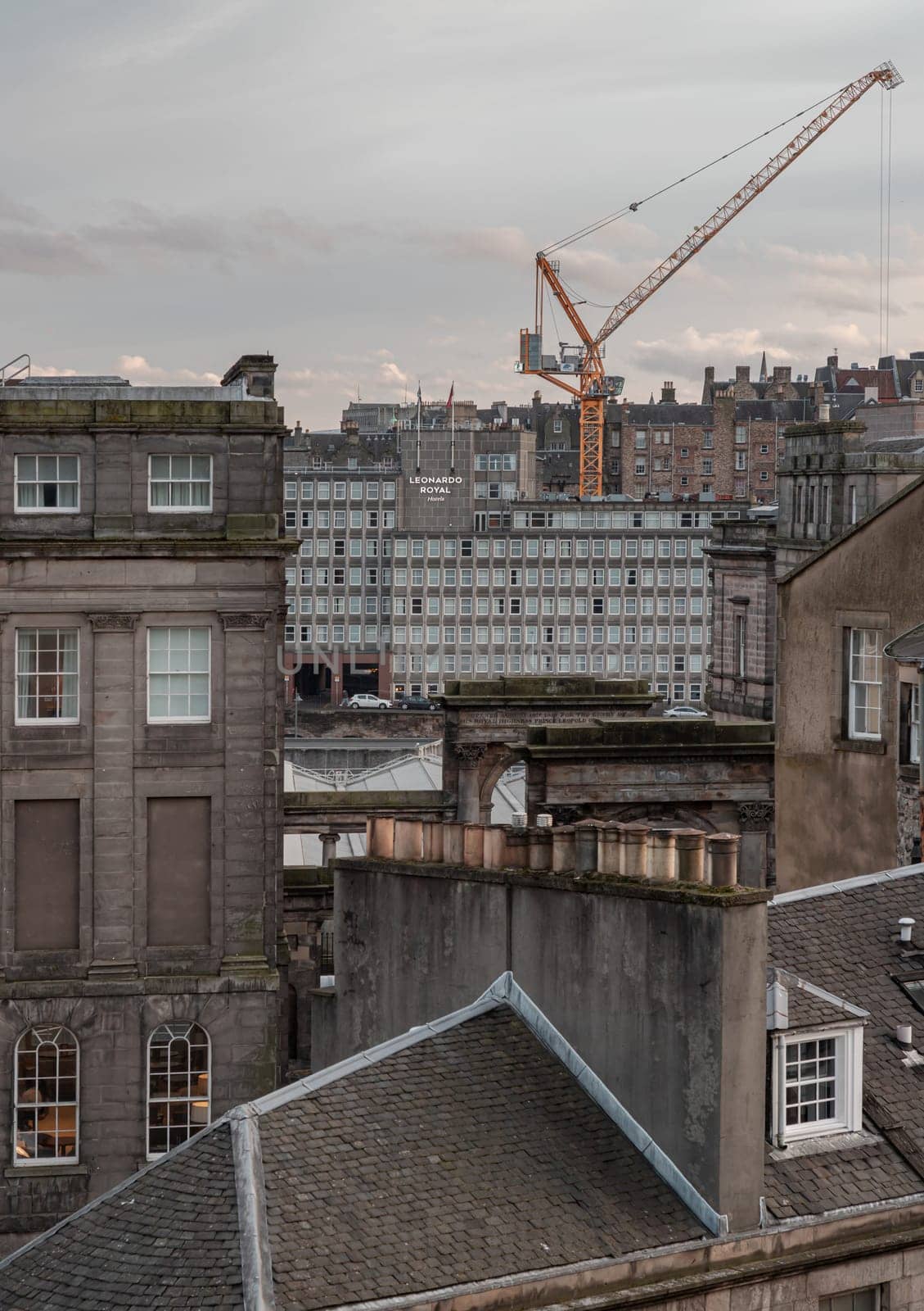 Edinburgh, Scotland - Jan 19, 2024 - View of urban brick buildings and Leonardo royal hotels with sky background in central Edinburgh. Destinations in Europe, Space for text, Selective focus.
