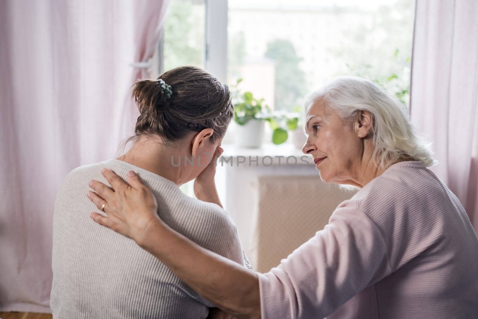 Aged mom encourage beloved adult girl child in difficult life situation.