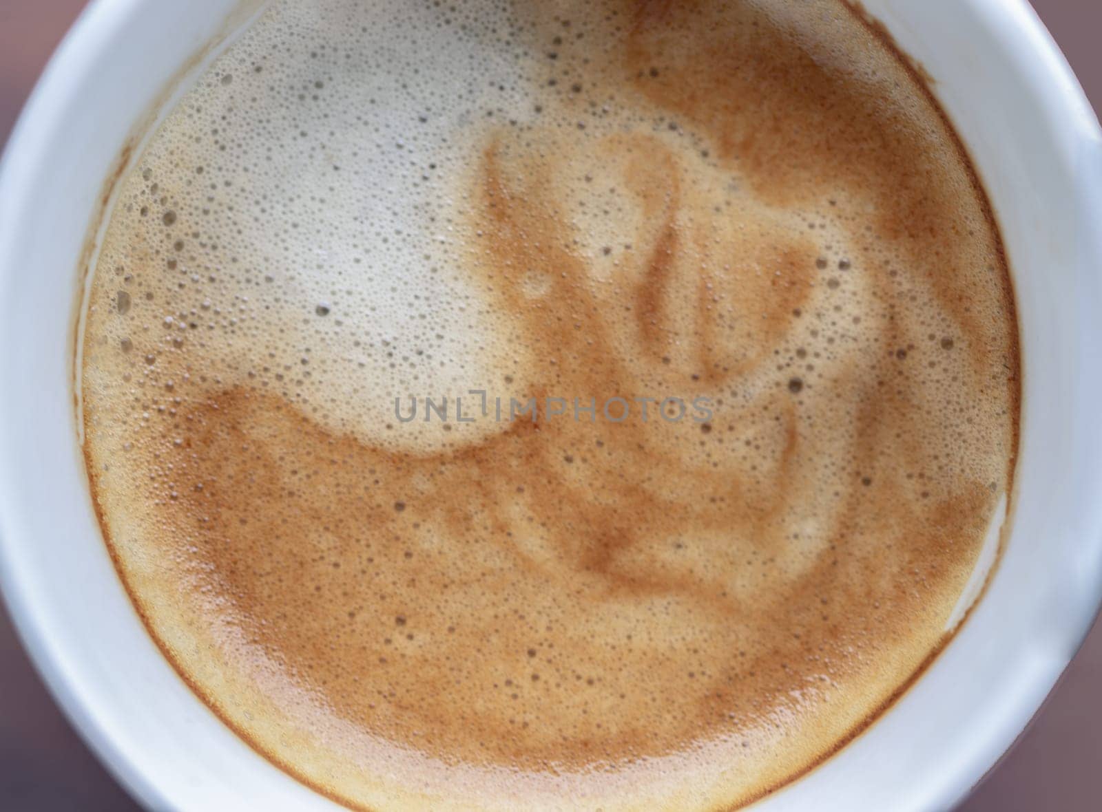 Top view of Cappuccino milk foam closeup. Very creamy coffee foam with bubbles, Coffee Time in the Morning, Top view, Space for text, Selective focus.