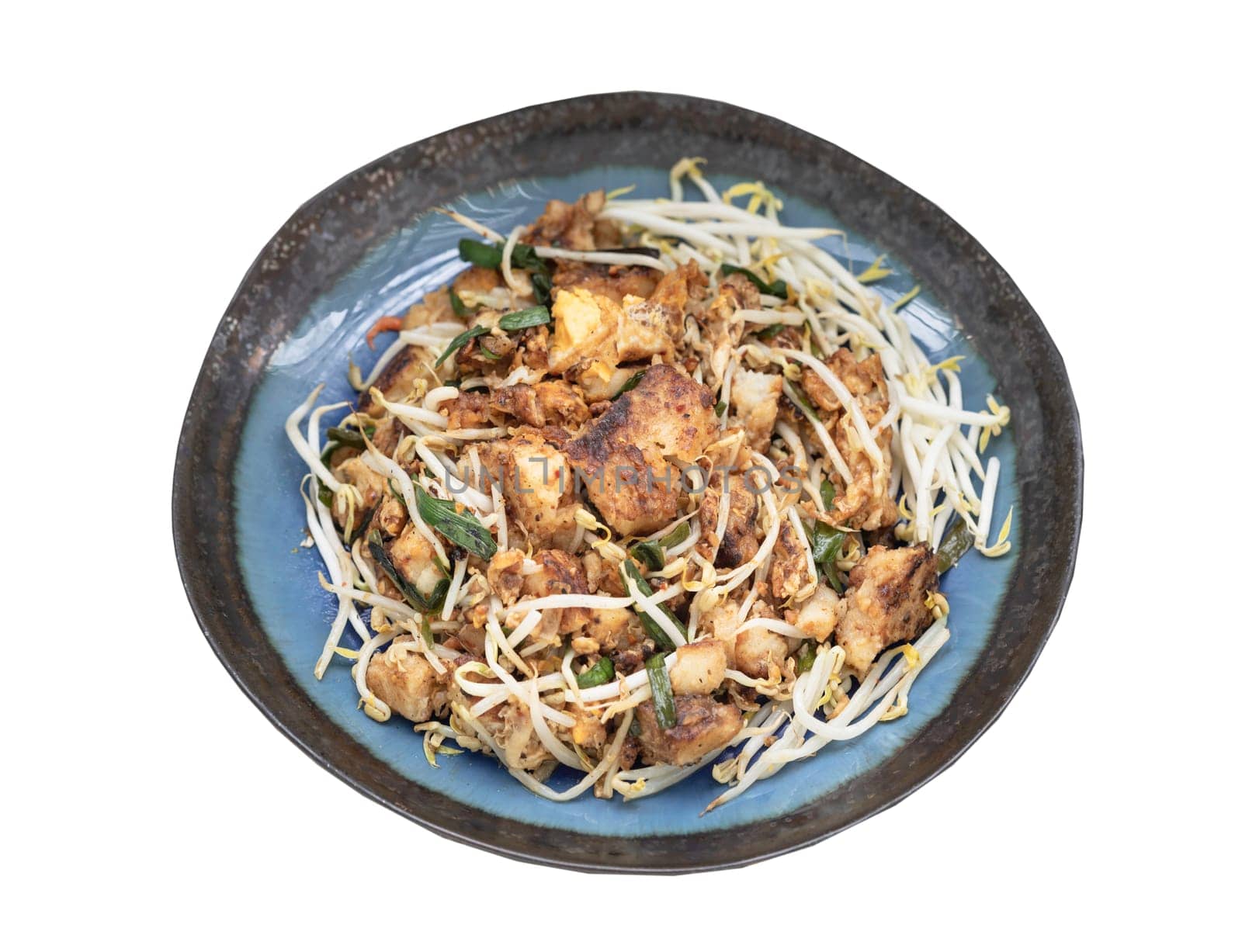 Stir-fried soft turnip cake or Fried radish cake (chai tow kway) with bean sprout and chives on ceramic plate isolated on white background with clipping path. Thai - Chinese food called Kanom Pak kad or Char Koay Kak, Top view, Selective focus.