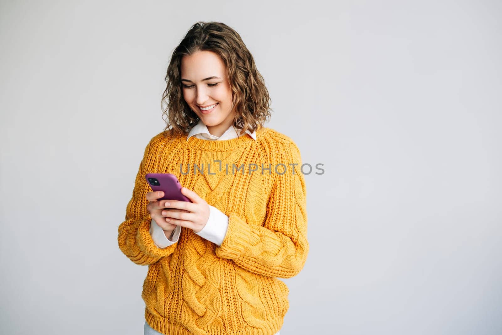 Young businesswoman, manager, or professional using her smartphone. She is engaged in corporate tasks, checking apps, and browsing online, showcasing technology in business.