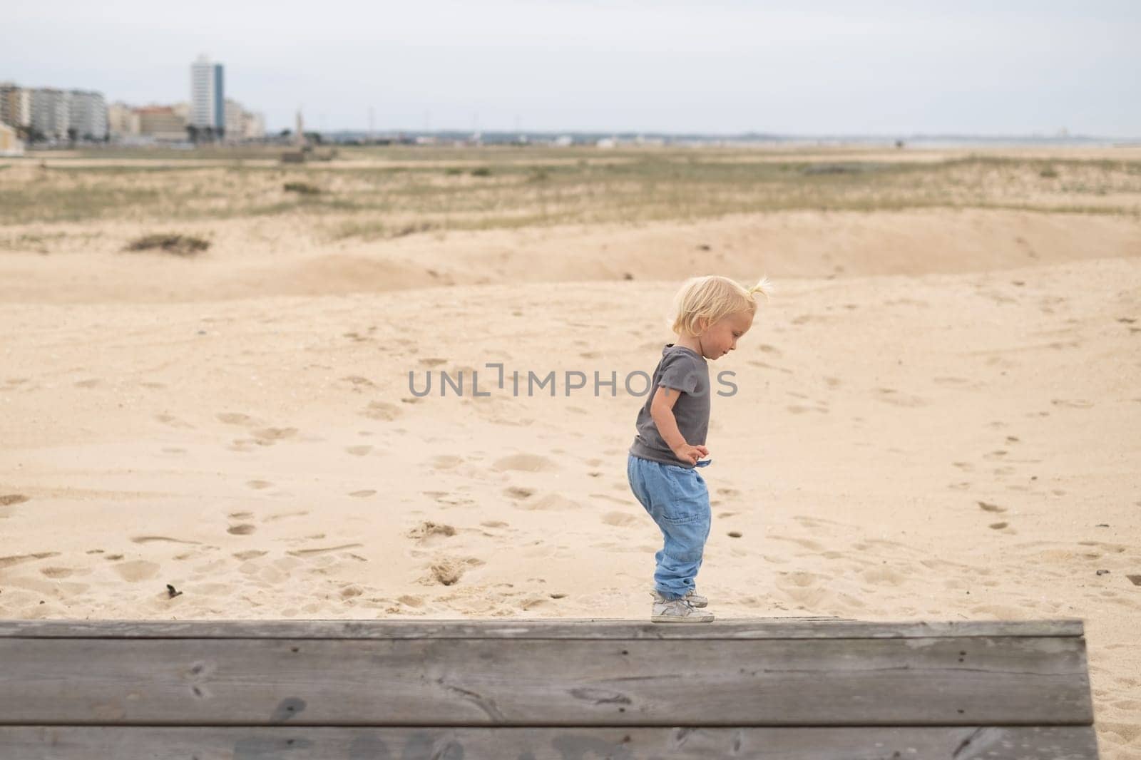 a cute girl walking on the sand beach