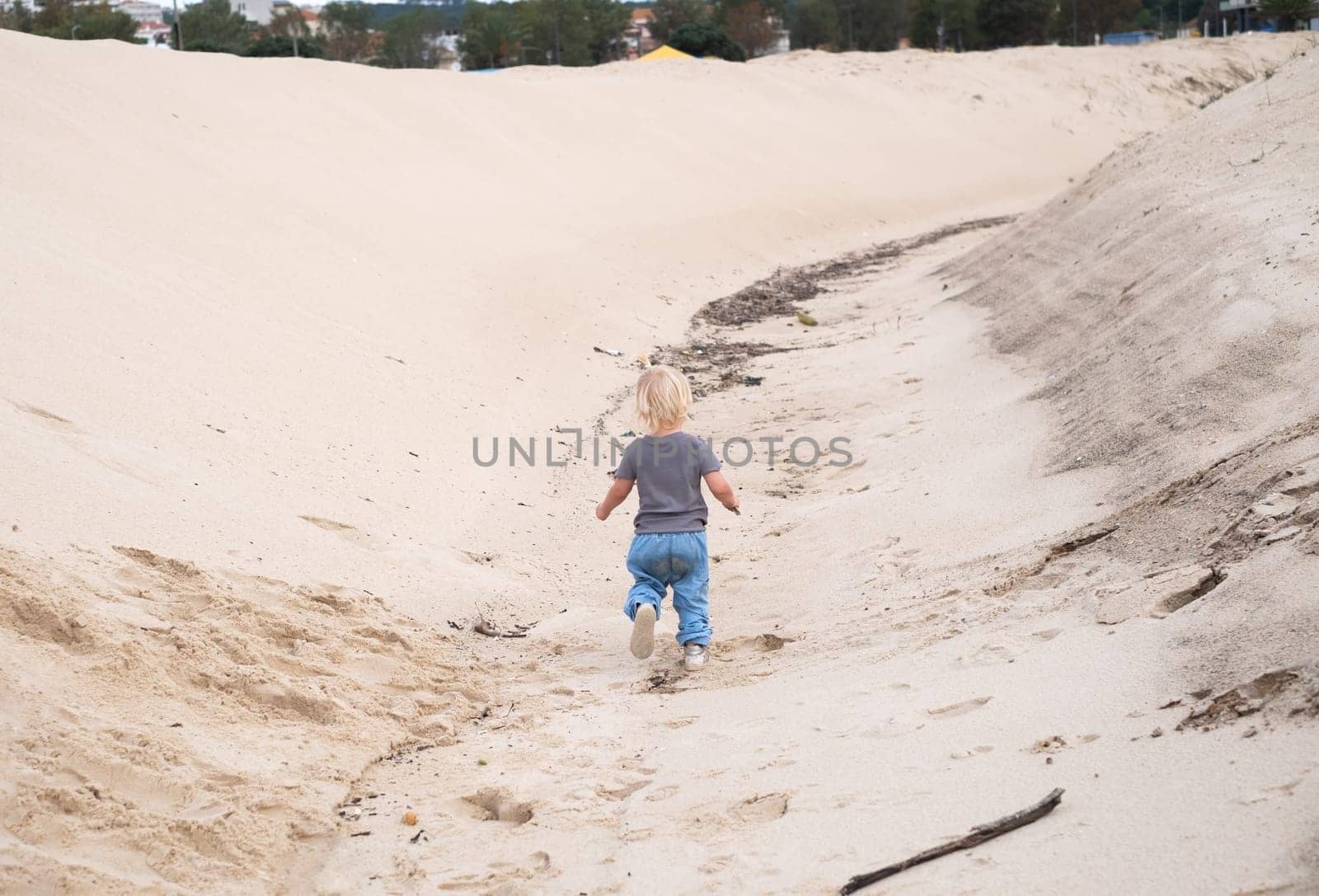 a cute girl walking on the sand beach