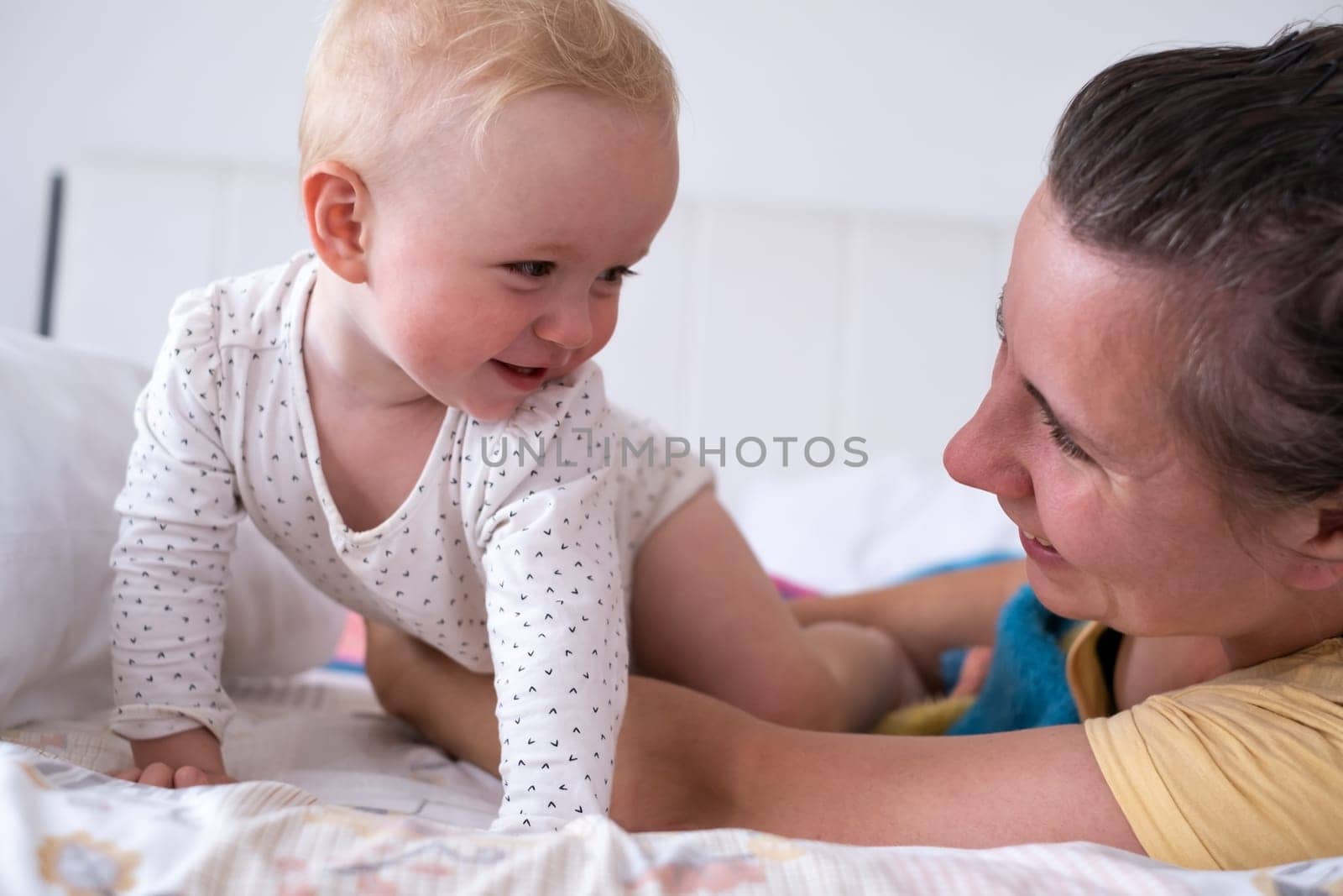 Mom and her daughter child girl are playing, smiling and hugging. Family holiday and togetherness.