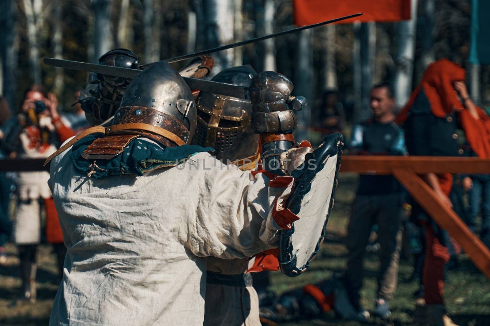 Knights in armor, helmets, with shields and swords. Reconstruction of jousting tournaments. Festival of historical clubs in the Park. Bishkek, Kyrgyzstan - October 13, 2019