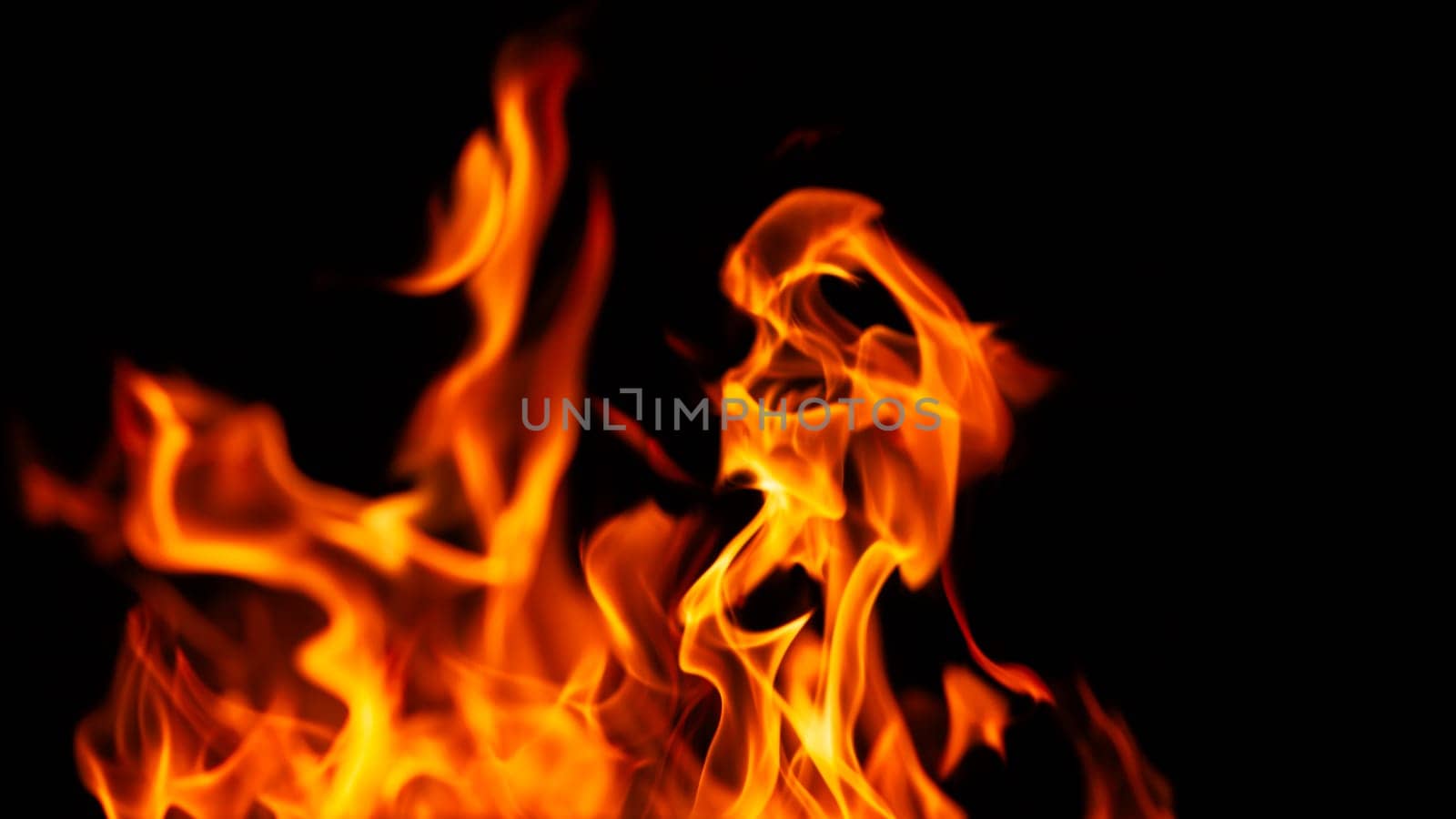 Decorative background with fire flames on black with copy space