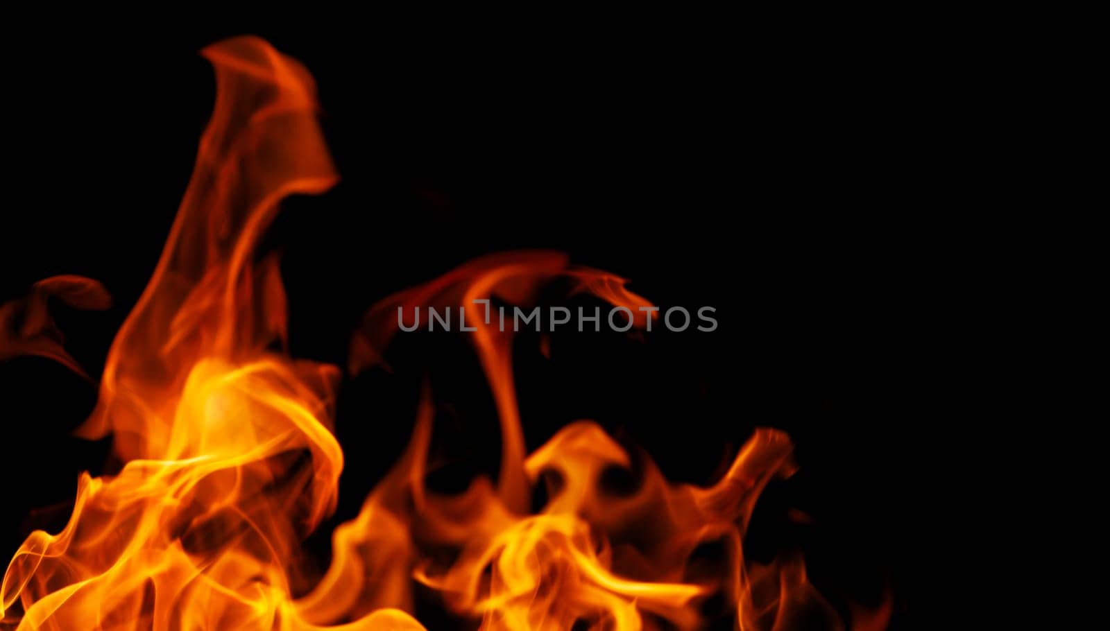 Decorative background with fire flames on black with copy space