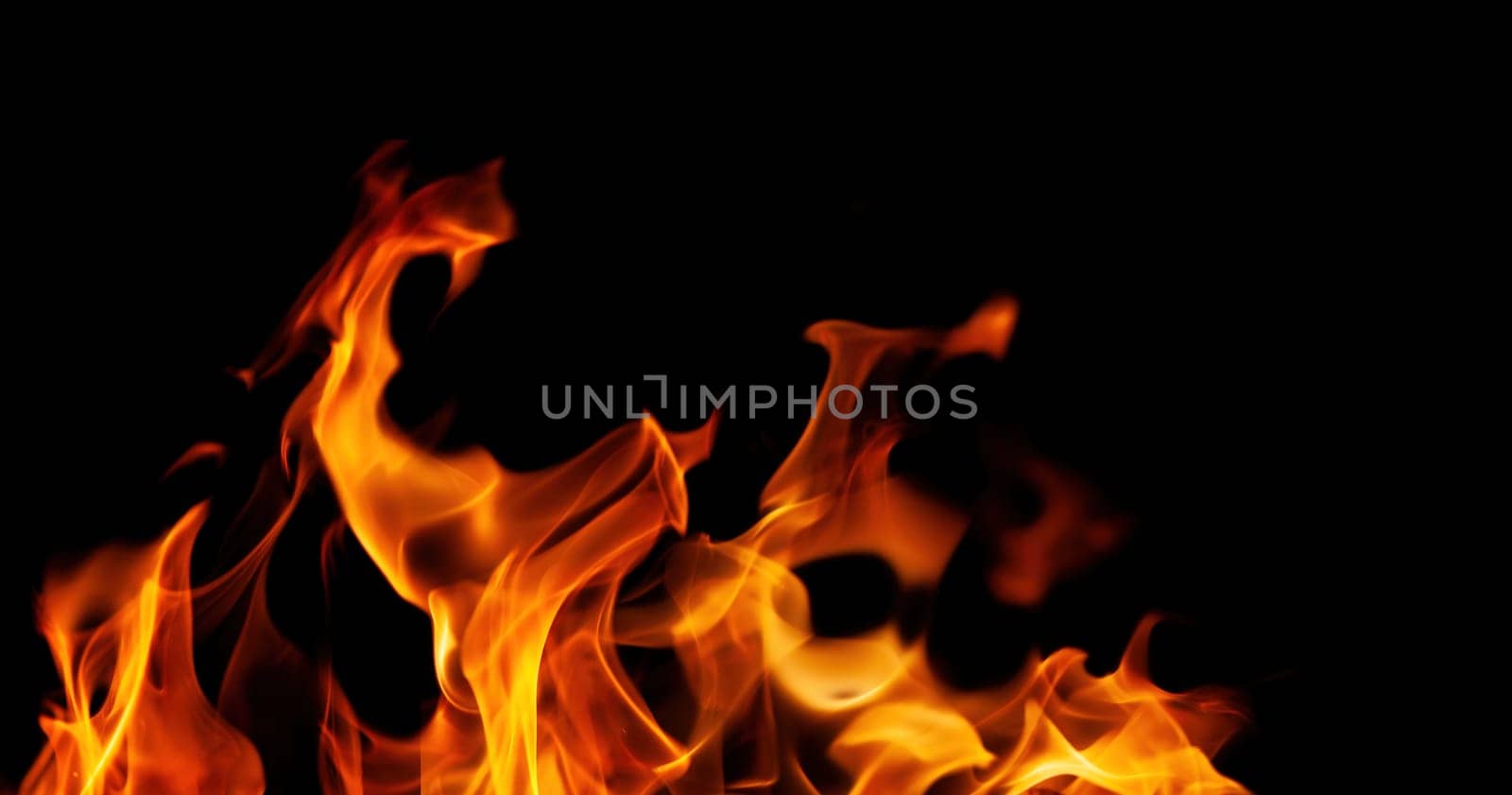 Decorative background with fire flames on black with copy space