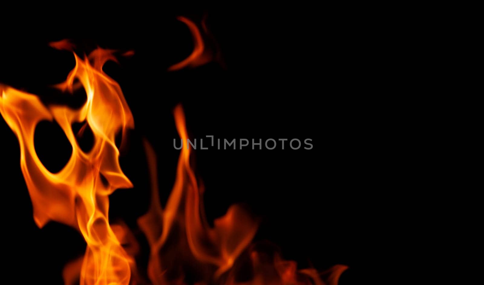Decorative background with fire flames on black with copy space