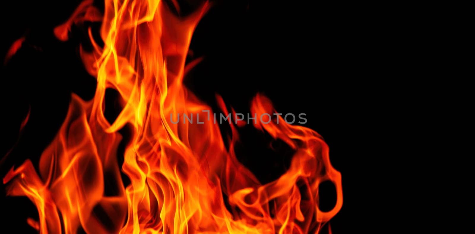 Decorative background with fire flames on black with copy space