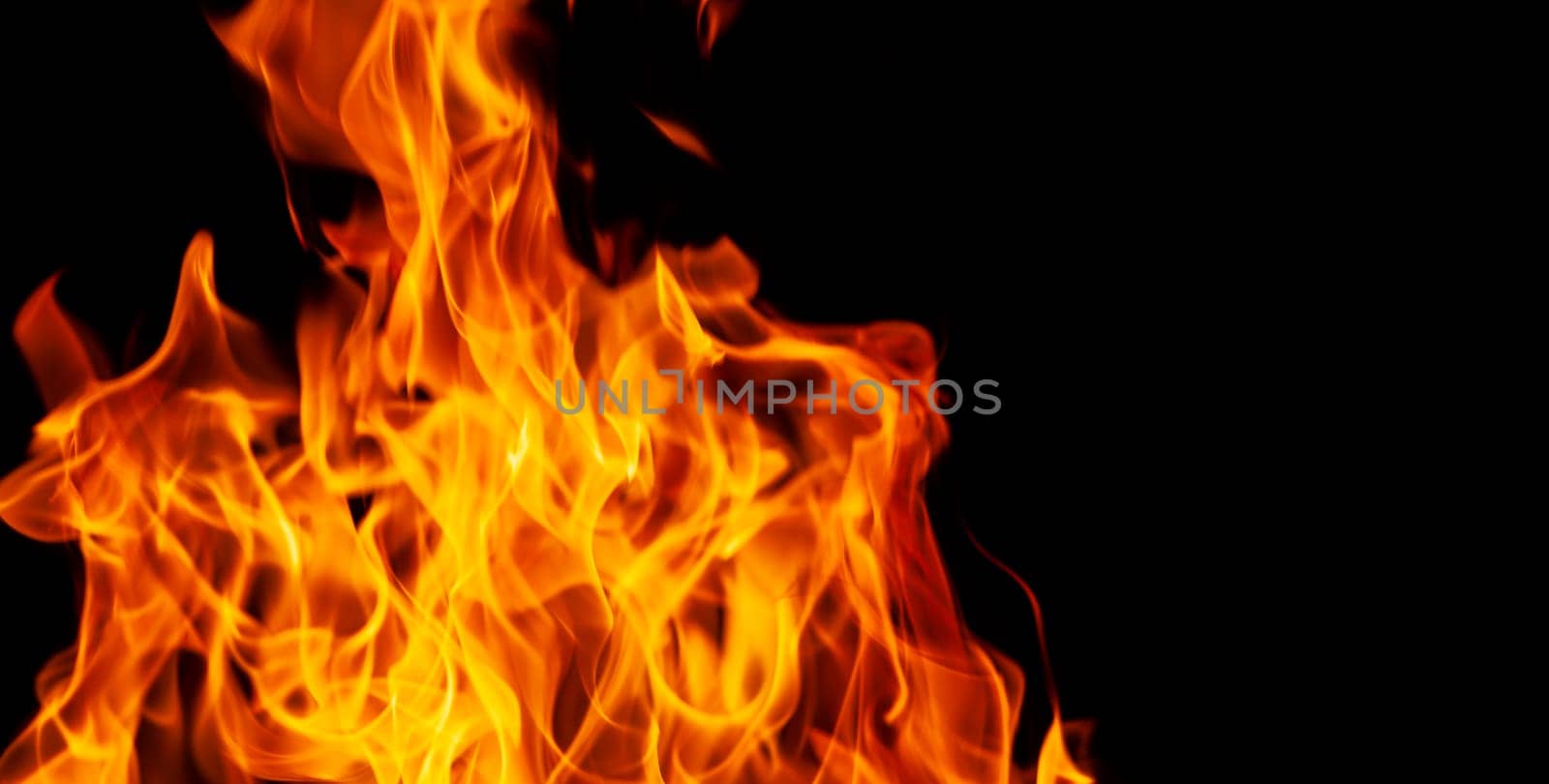 Decorative background with fire flames on black with copy space