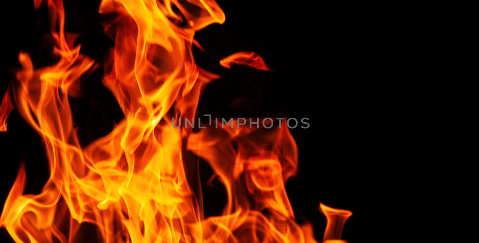 Decorative background with fire flames on black with copy space