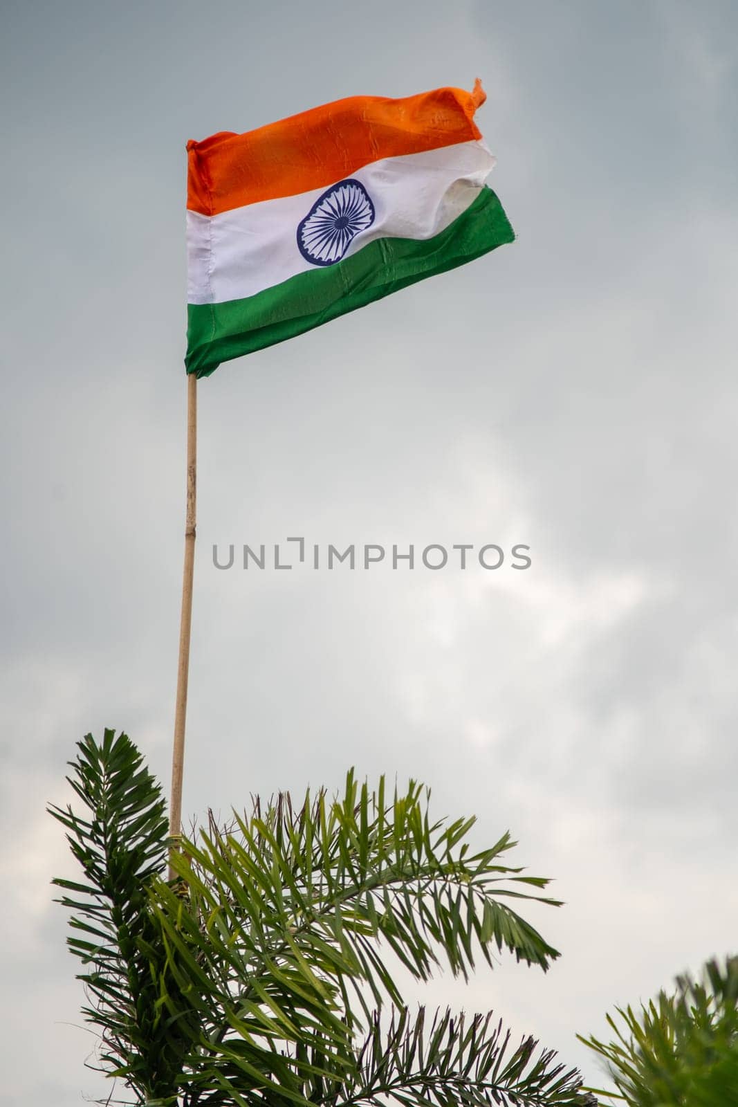 Indian tricolor flag against storm cloudy sky showing national pride and celebration of independence and republic day and the tough times for India ahead