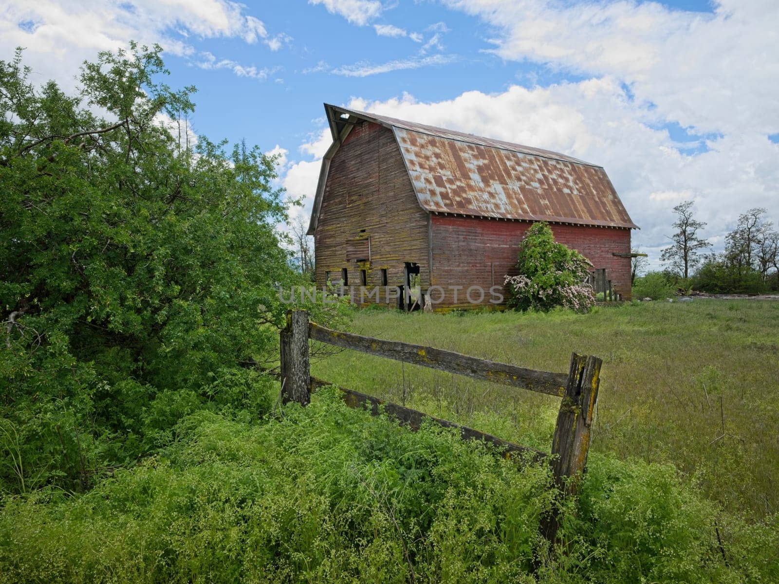 A landscape photo of an old abandoned barn under a dramatic cloudy sky in north Idaho.