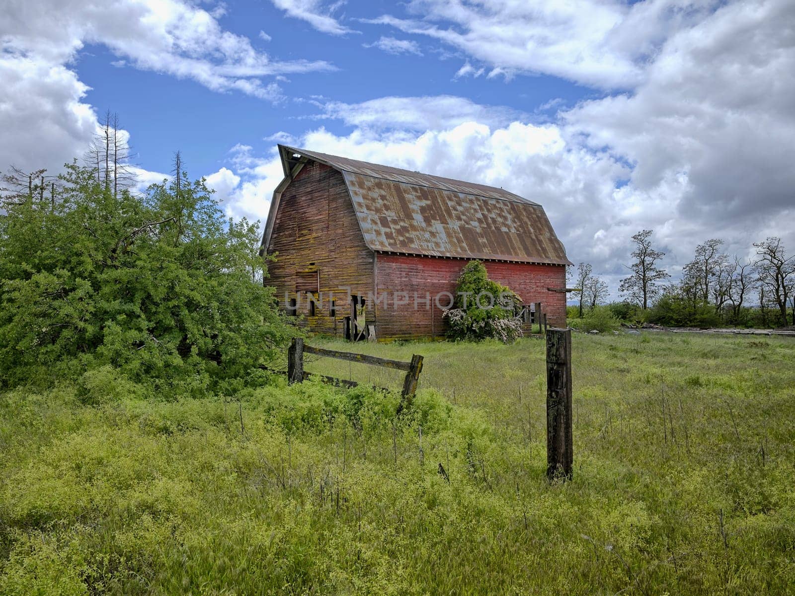 A landscape photo of an old abandoned barn under a dramatic cloudy sky in north Idaho.