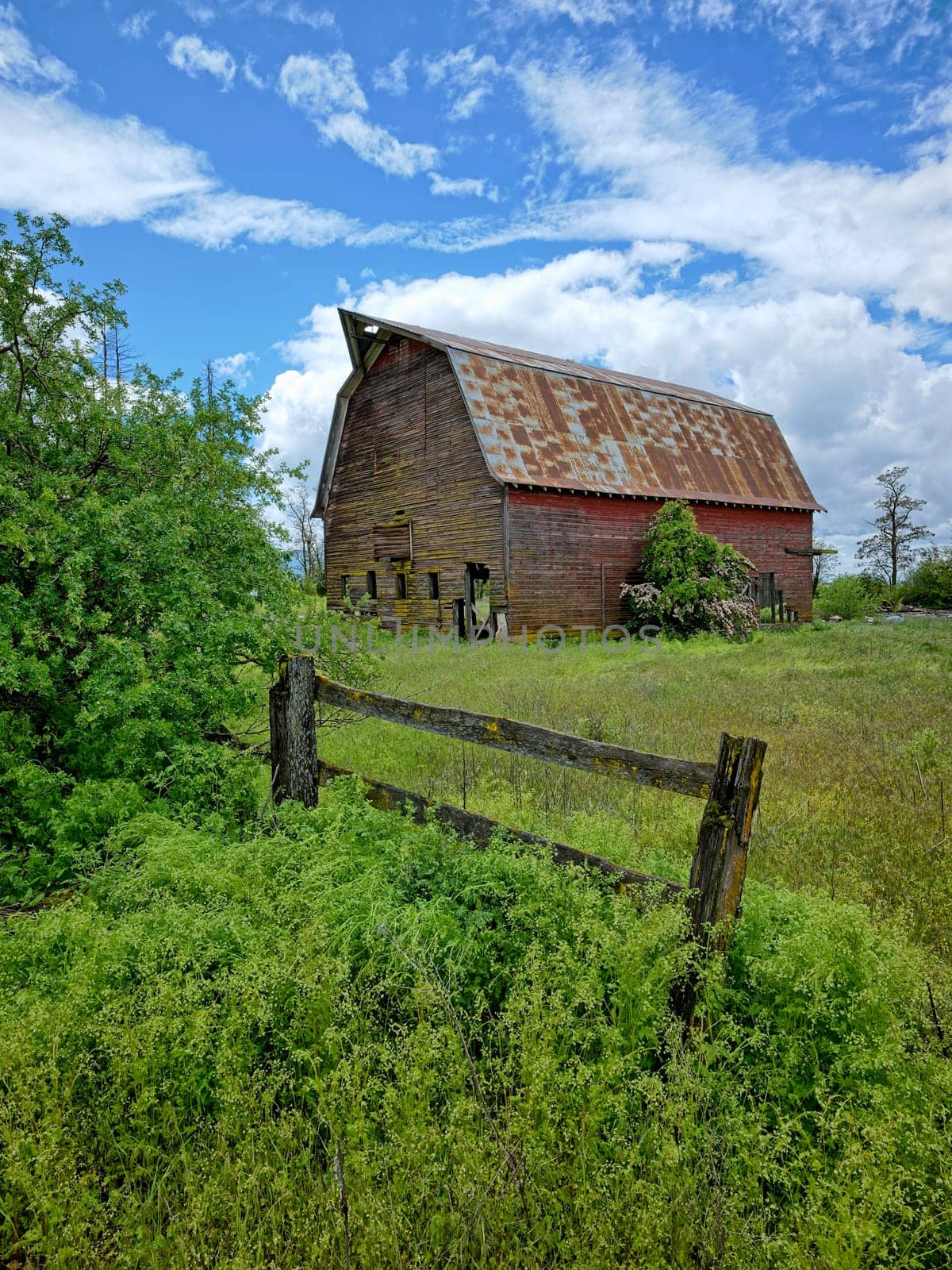 A landscape photo of an old abandoned barn under a dramatic cloudy sky in north Idaho.