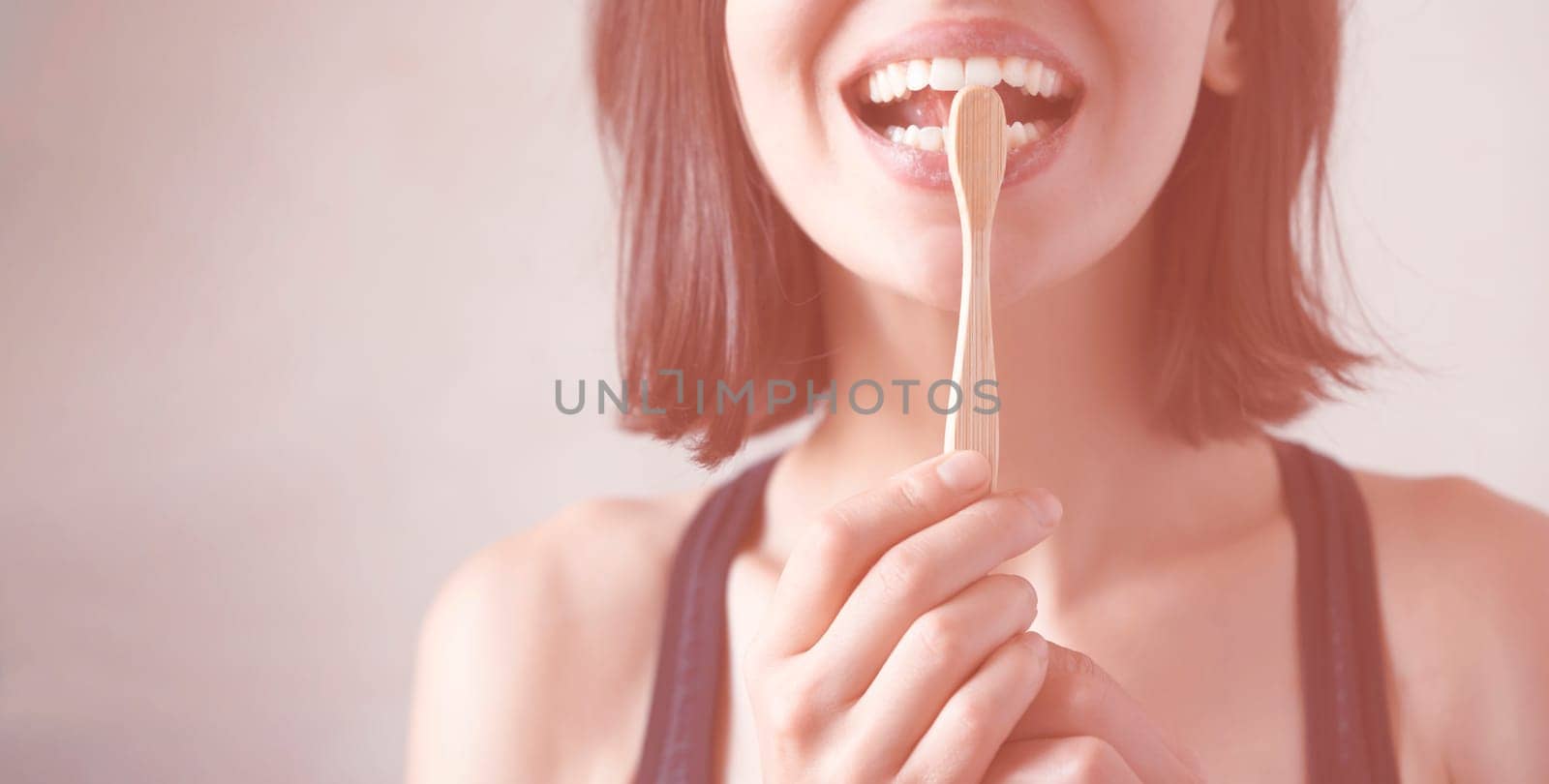 A young girl flosses her teeth, a woman takes good care of her snow-white smile, the health of her gums and tooth enamel.