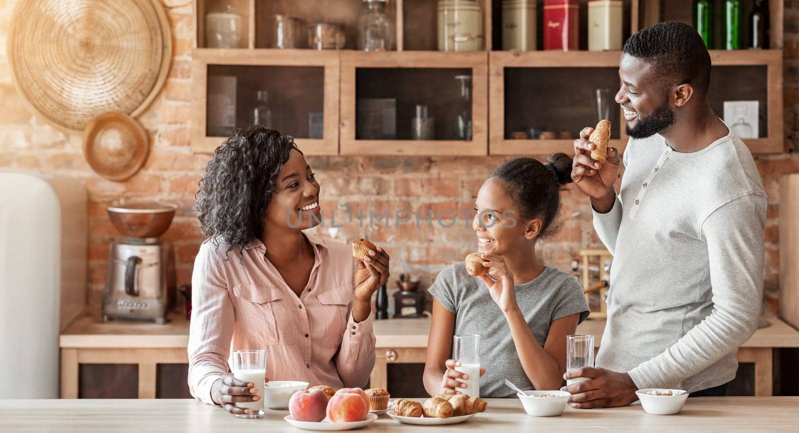 Friendly african american family having conversation during breakfast at kitchen, happy cozy atmosphere, copy space
