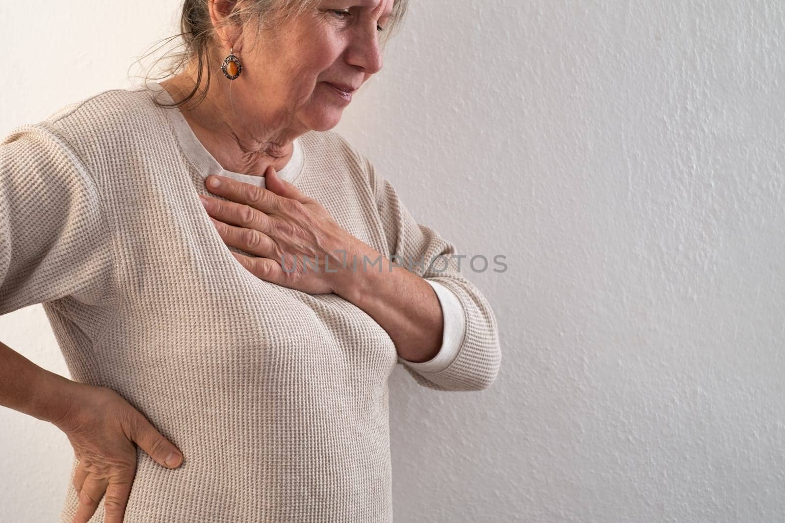 Woman having a pain in the heart area. Heart Attack. Painful Chest.