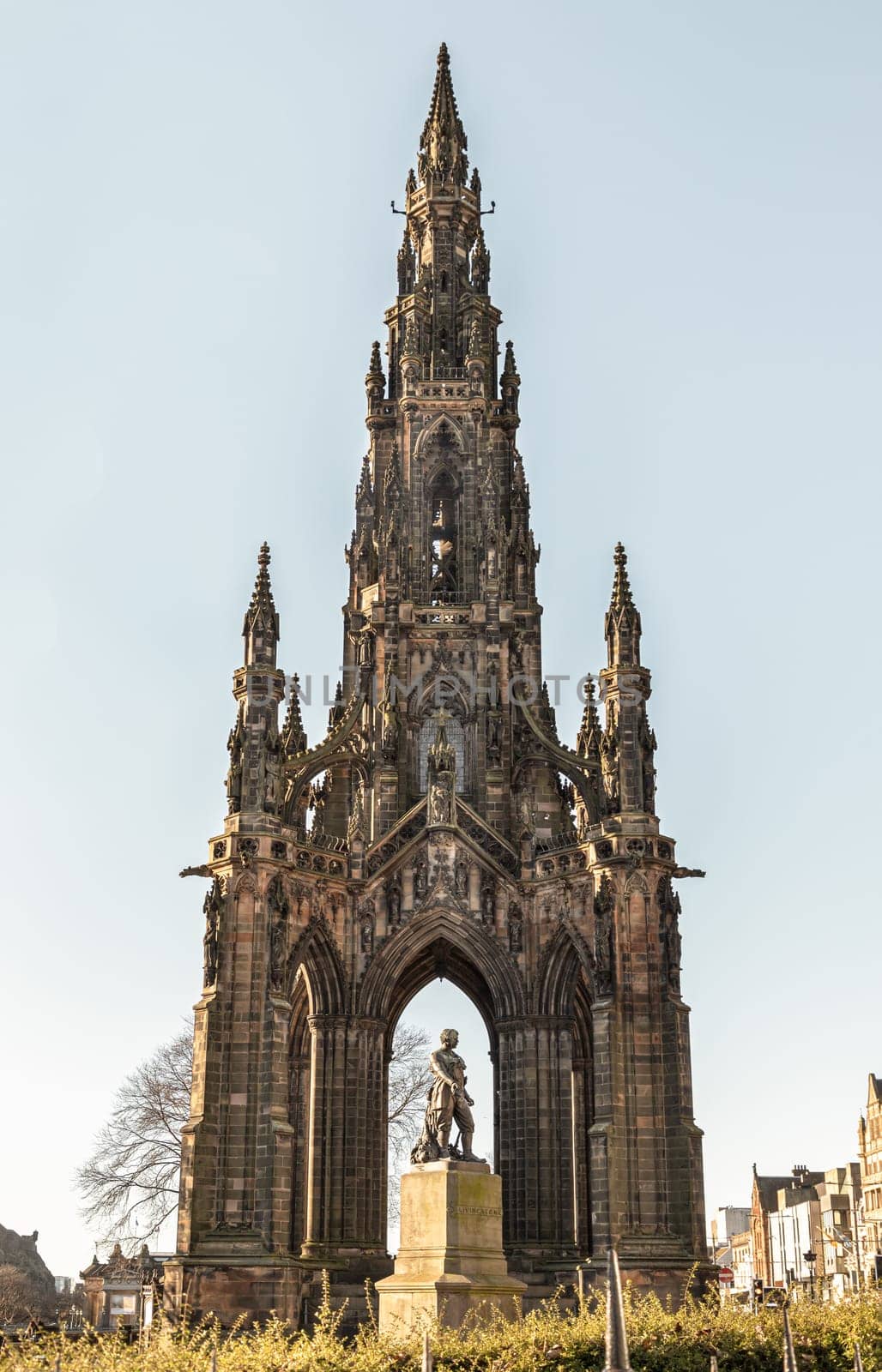 Edinburgh, Scotland - Jan 16, 2024 - The statue of Explorer David Livingstone in front of The Scott Monument is a Victorian Gothic monument in Princes Street Gardens at the city of Edinburgh. Space for text, Selective focus.