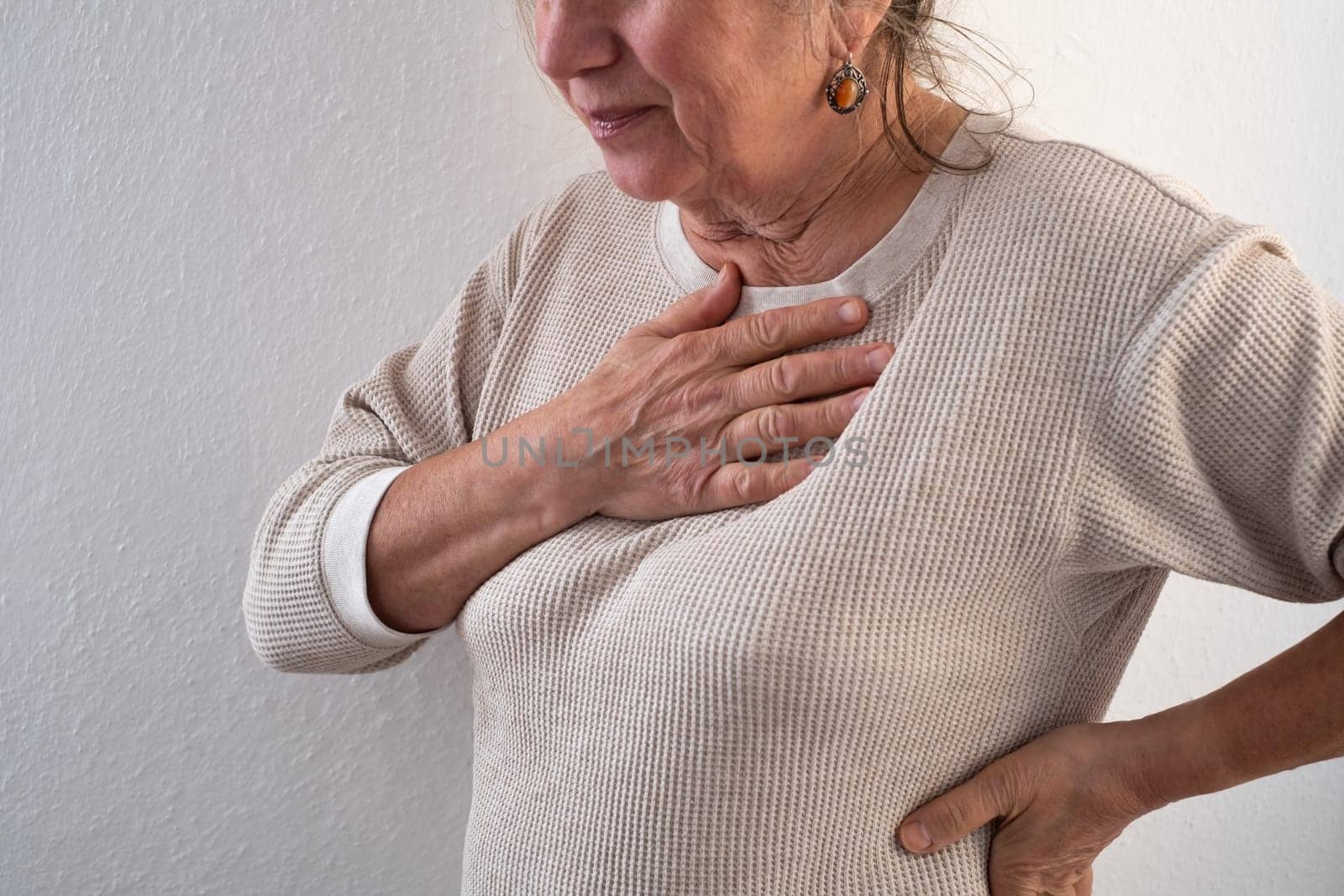 Woman having a pain in the heart area. Heart Attack. Painful Chest.