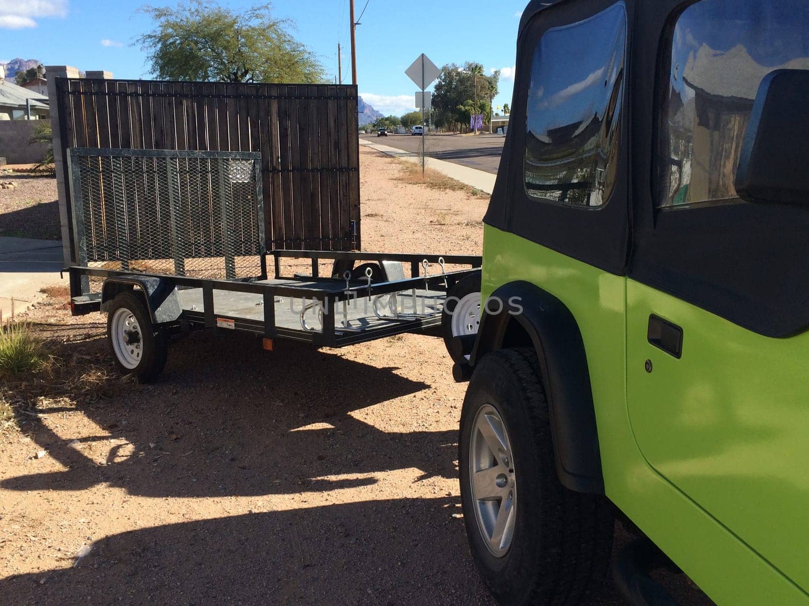 Green SUV Pulling Trailer, Just Hitched it up in my Driveway . High quality photo